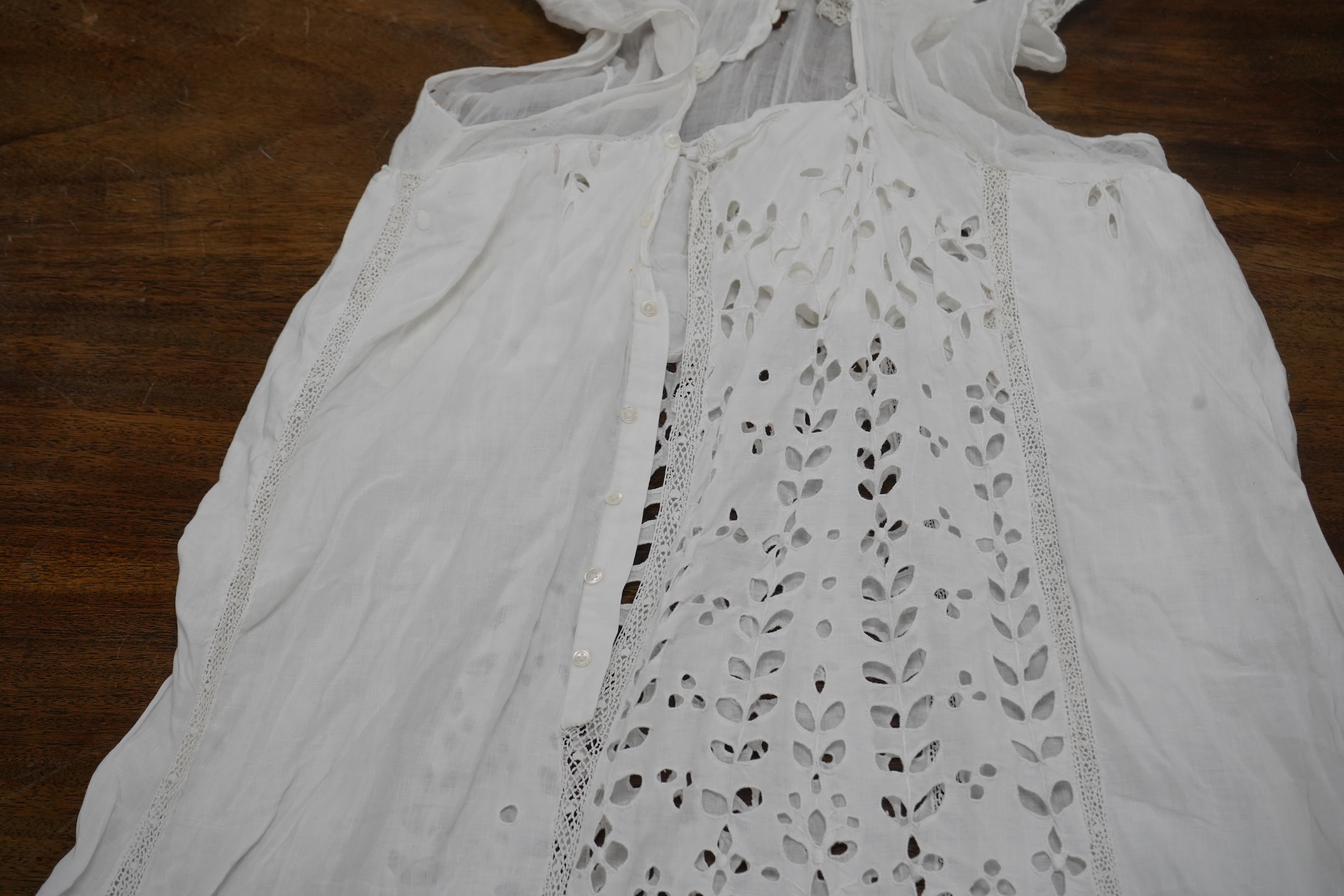 An Edwardian fine white embroidery anglaise and Irish crochet trimmed ladies summer dress, designed with large panels of anglaise cut work, the dress has been altered and restyled, which could be altered back, 134cm long